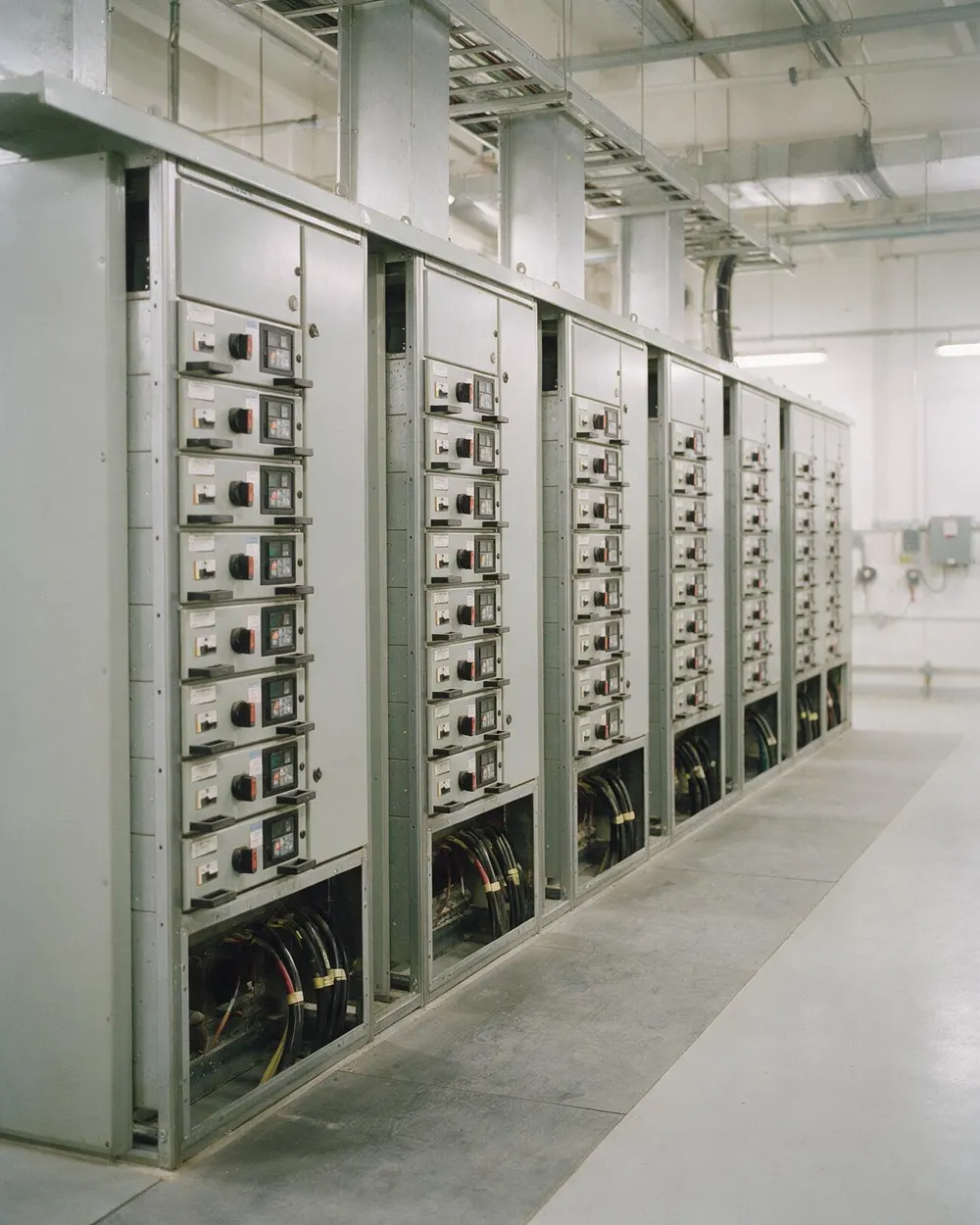 A row of motor control centre cubicles with starter drawers and cable entries
